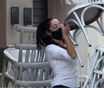 Mujer, camarera, poniendo sillas en terraza